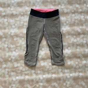 Adorable black and white striped capris with pink accents and cute side detail.